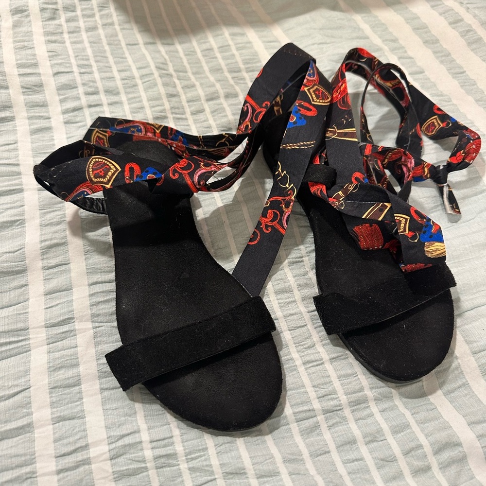Black sandals with ankle straps.